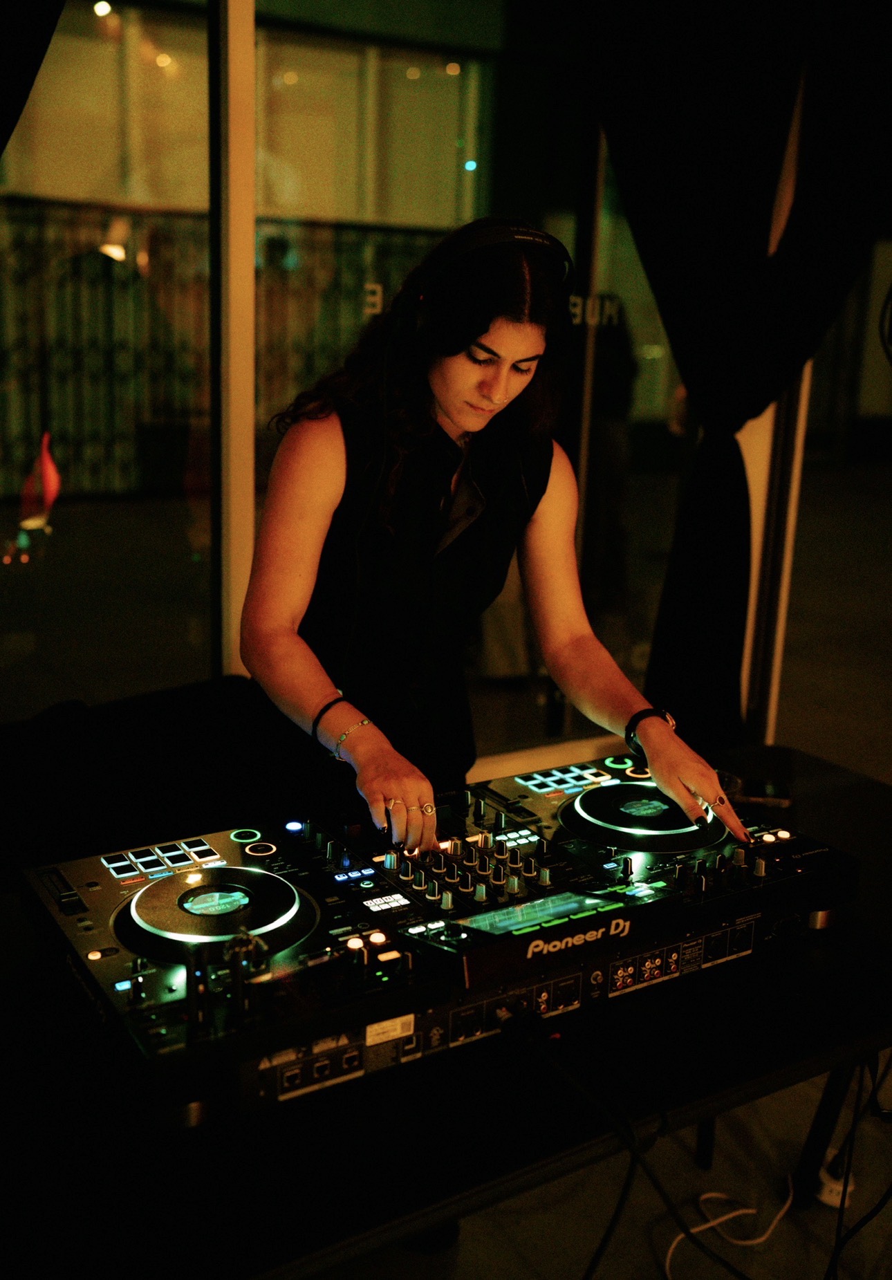 DJ mixing techno on Pioneer decks at a Los Angeles night event